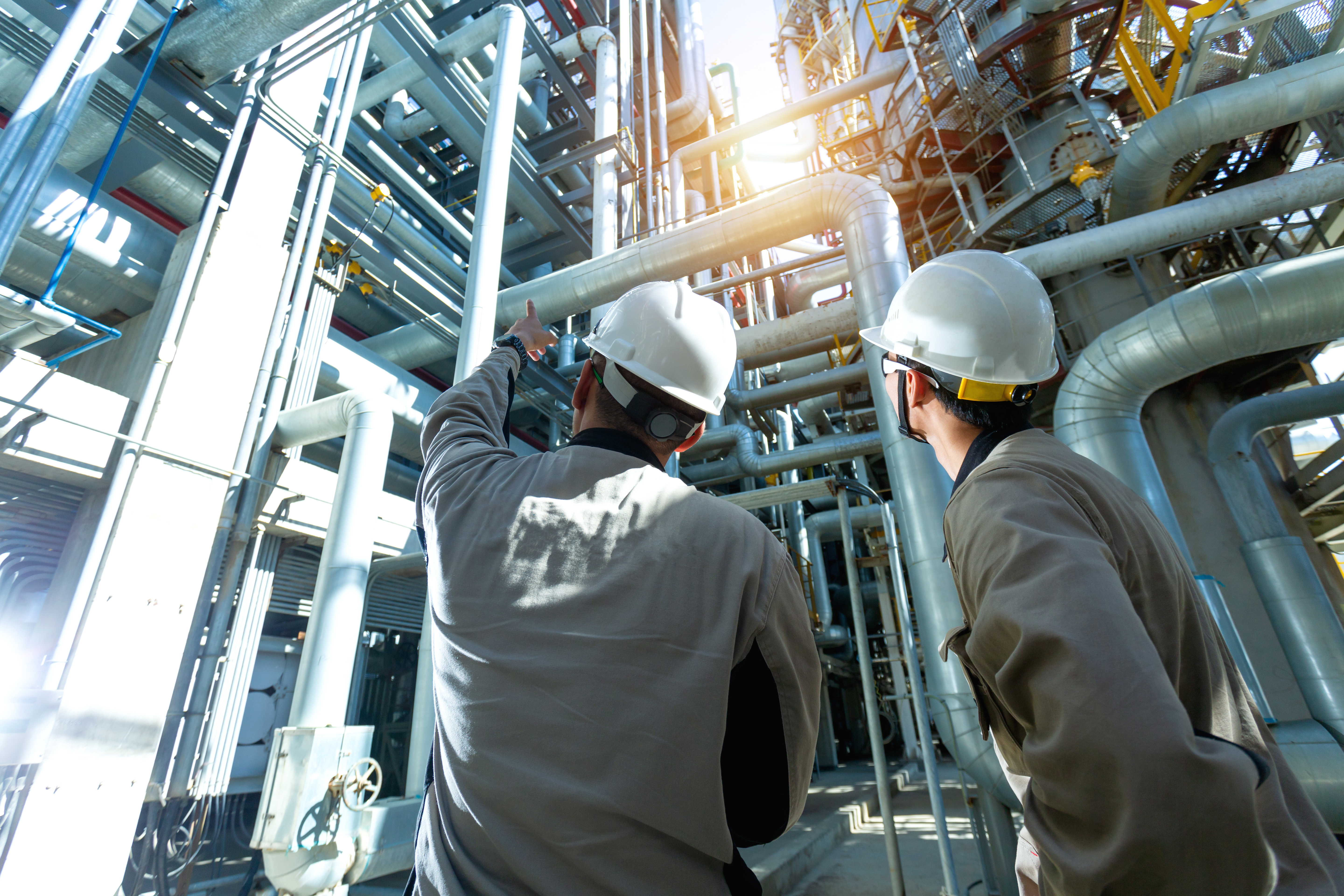 Industrial engineer or worker checking pipeline at oil and gas r